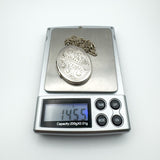 Full locket and chain weighing 14.55g displayed on digital jewellery scale
