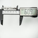 Digital caliper showing inside width measurement of bangle at 60.9mm