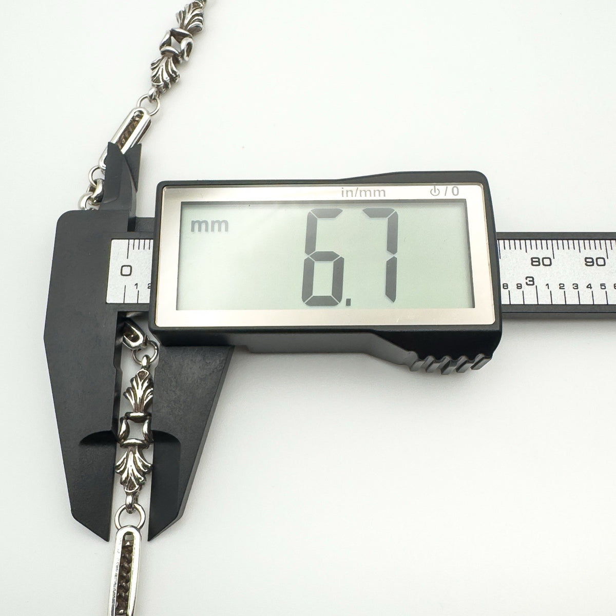 Fleur De Lys link width of 6.7mm shown with calipers