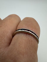 Stacking eternity band with rubies and sapphires worn showing mixed colour