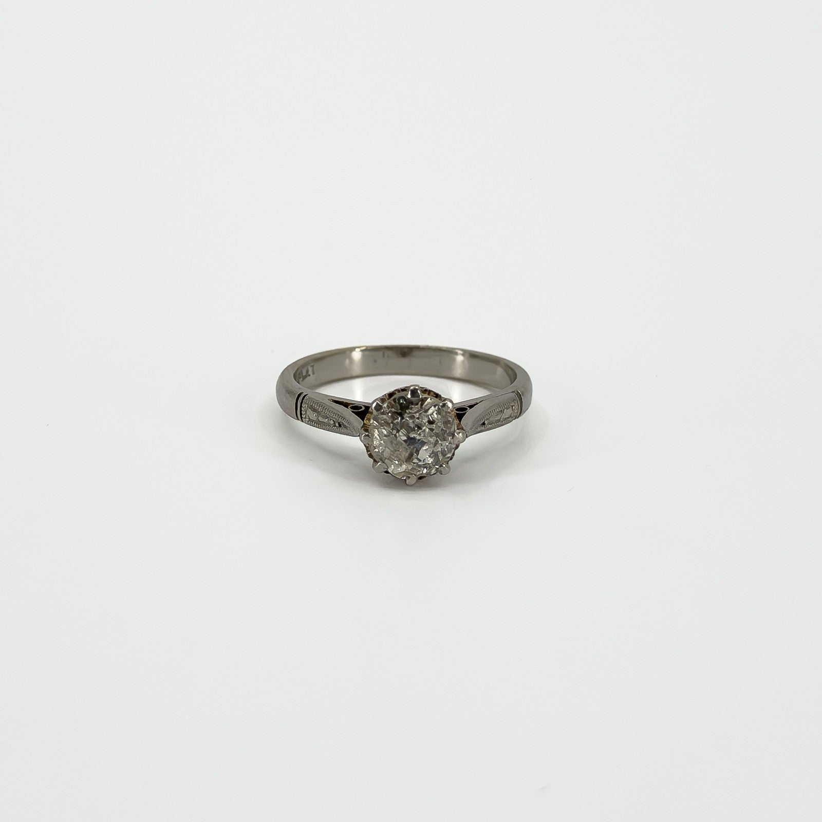 Straight-on view of antique platinum solitaire ring with old-cut diamond in eight-claw setting
