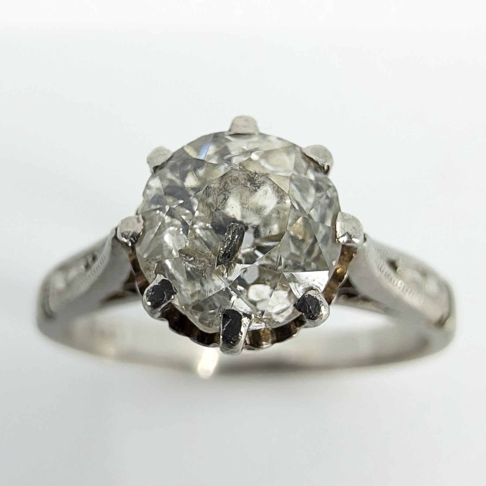 Close up of antique old-cut diamond in eight-claw platinum solitaire ring setting