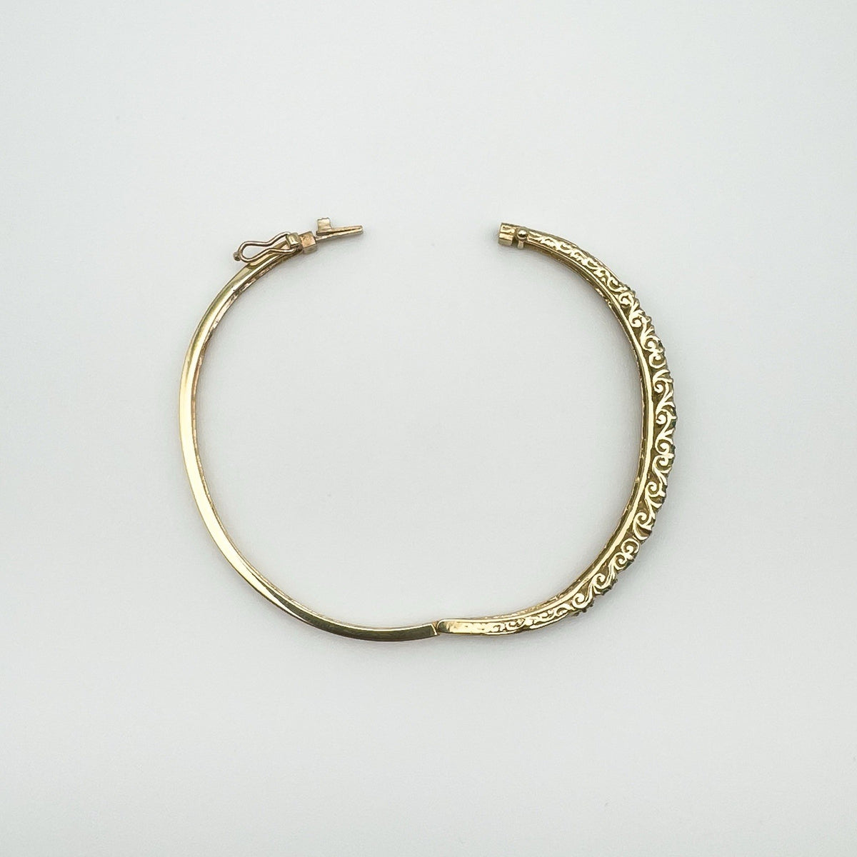 Vintage oval bangle open showing push clasp and scroll pattern