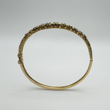 Raised floral design on vintage 9ct gold emerald bangle