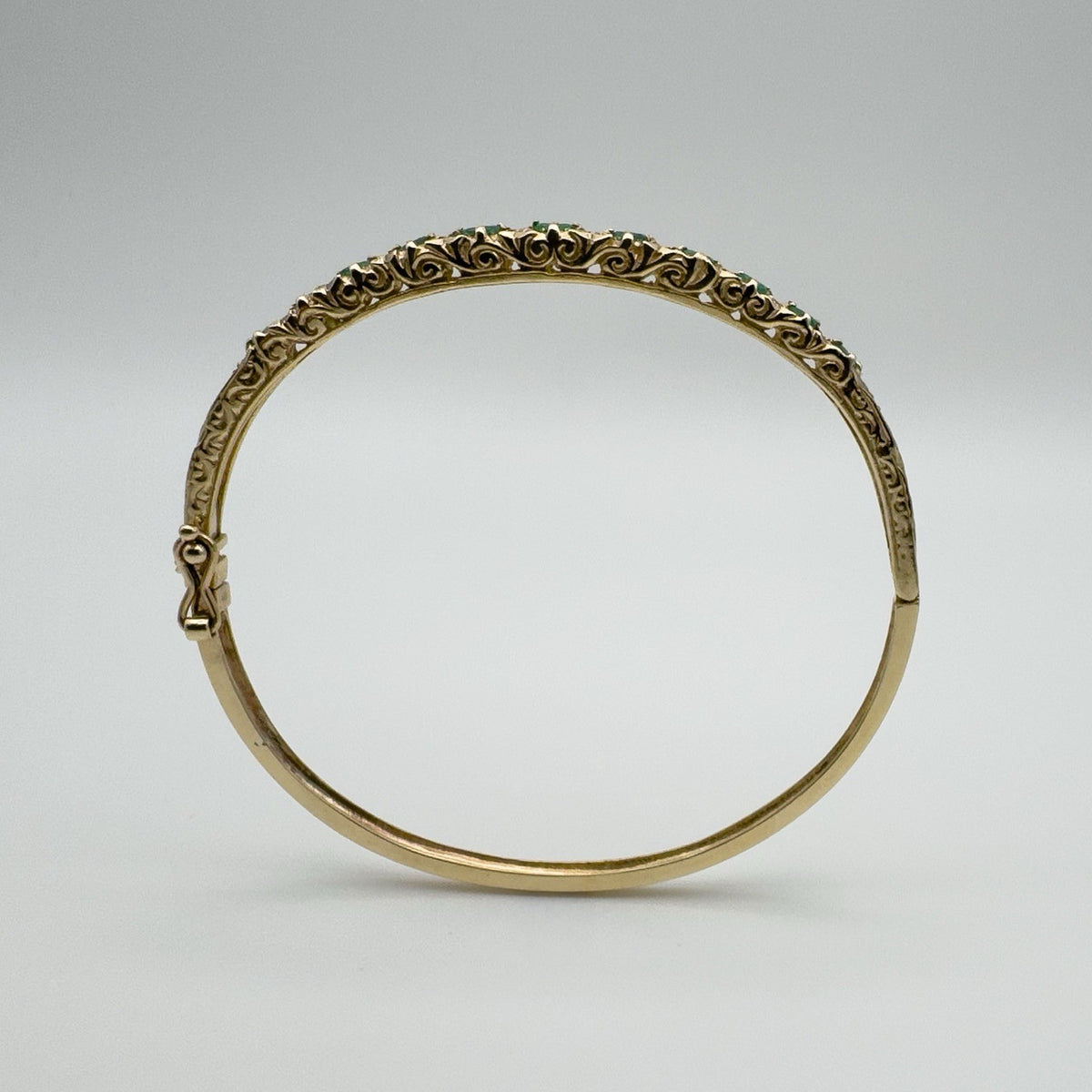 Raised floral design on vintage 9ct gold emerald bangle