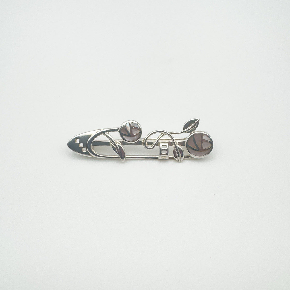 Overhead image of Celtic brooch with mother of pearl rose design