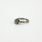 Side view of antique platinum diamond solitaire ring with PLAT stamp visible inside the band