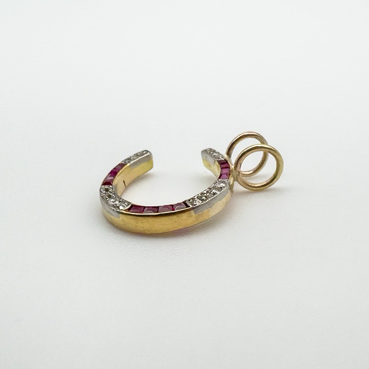 Side angle of antique 9ct gold pendant showing ruby and diamond setting