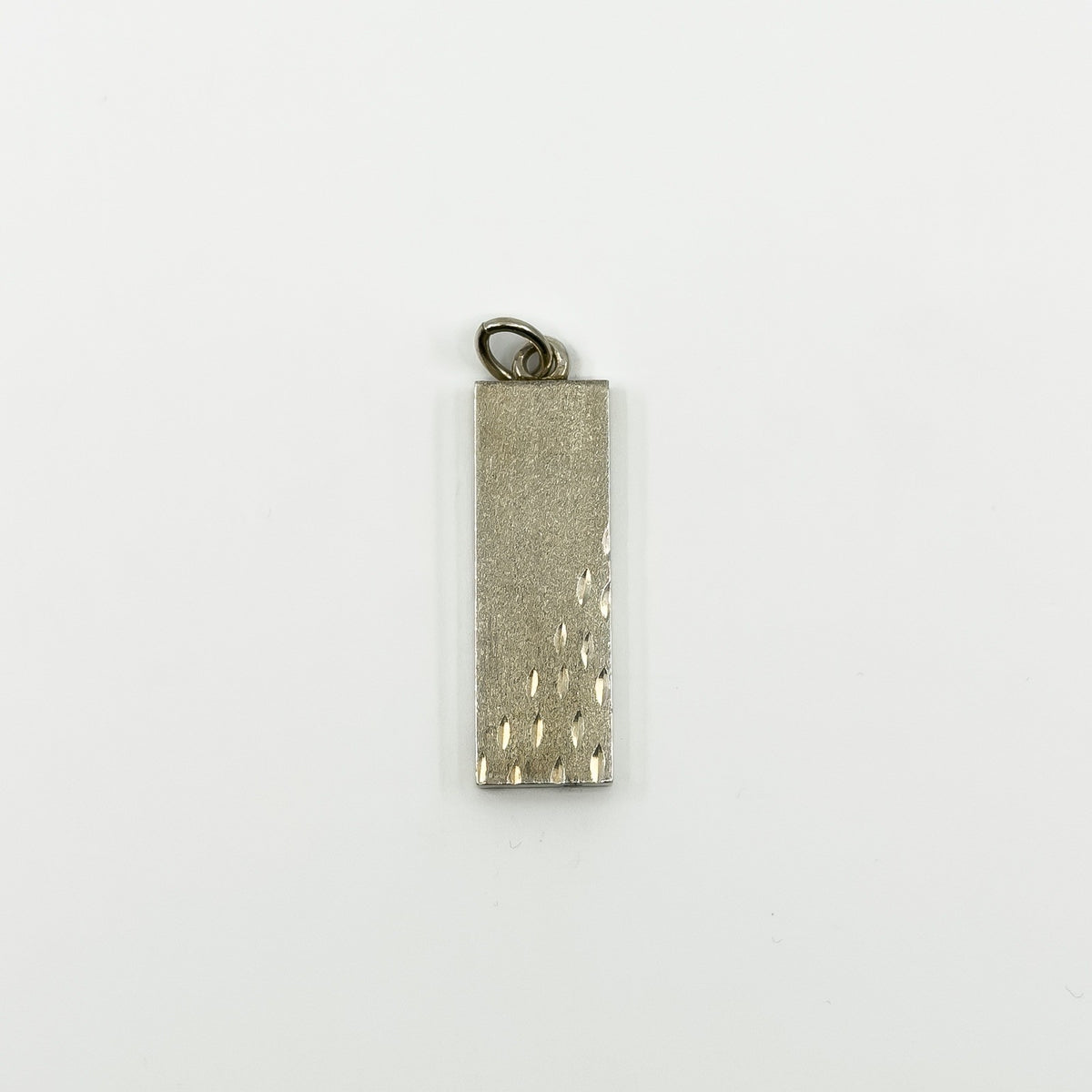 Plain reverse side of chunky vintage sterling silver ingot pendant with textured finish