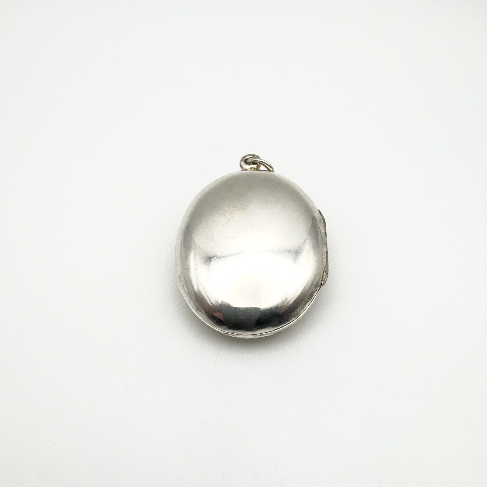 Smooth polished reverse side of vintage silver buckle locket