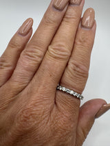 Platinum full eternity ring with natural diamonds shown on finger