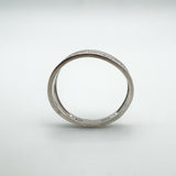 Side profile of diamond half hoop ring showing hallmarks inside the band