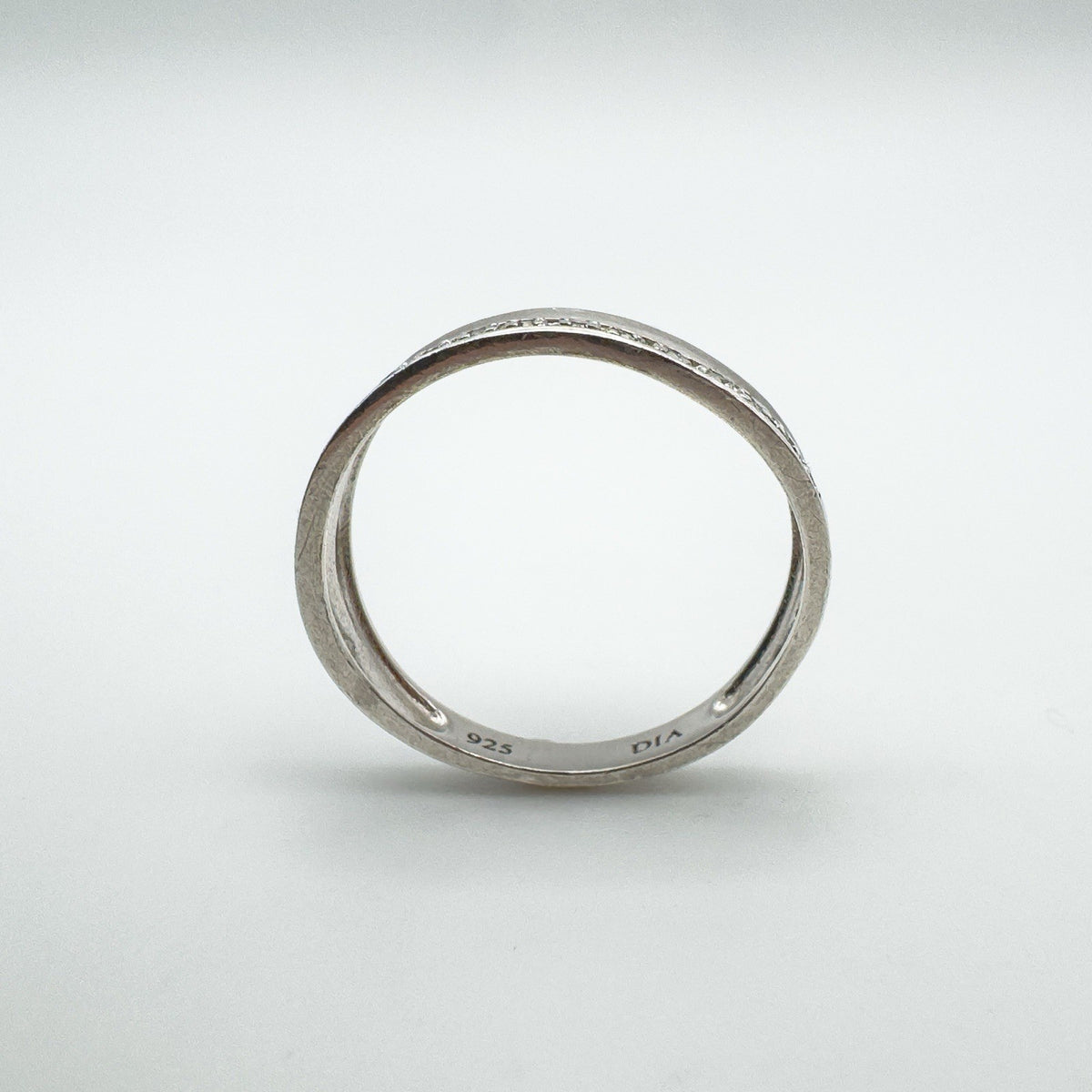 Side profile of diamond half hoop ring showing hallmarks inside the band