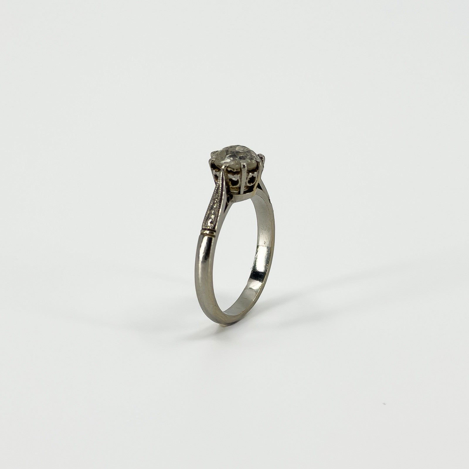 Side view of antique platinum solitaire ring with raised old-cut diamond claw setting