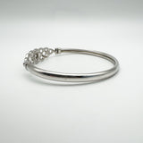 Right angle showing the bangle’s sleek form and hinge detail