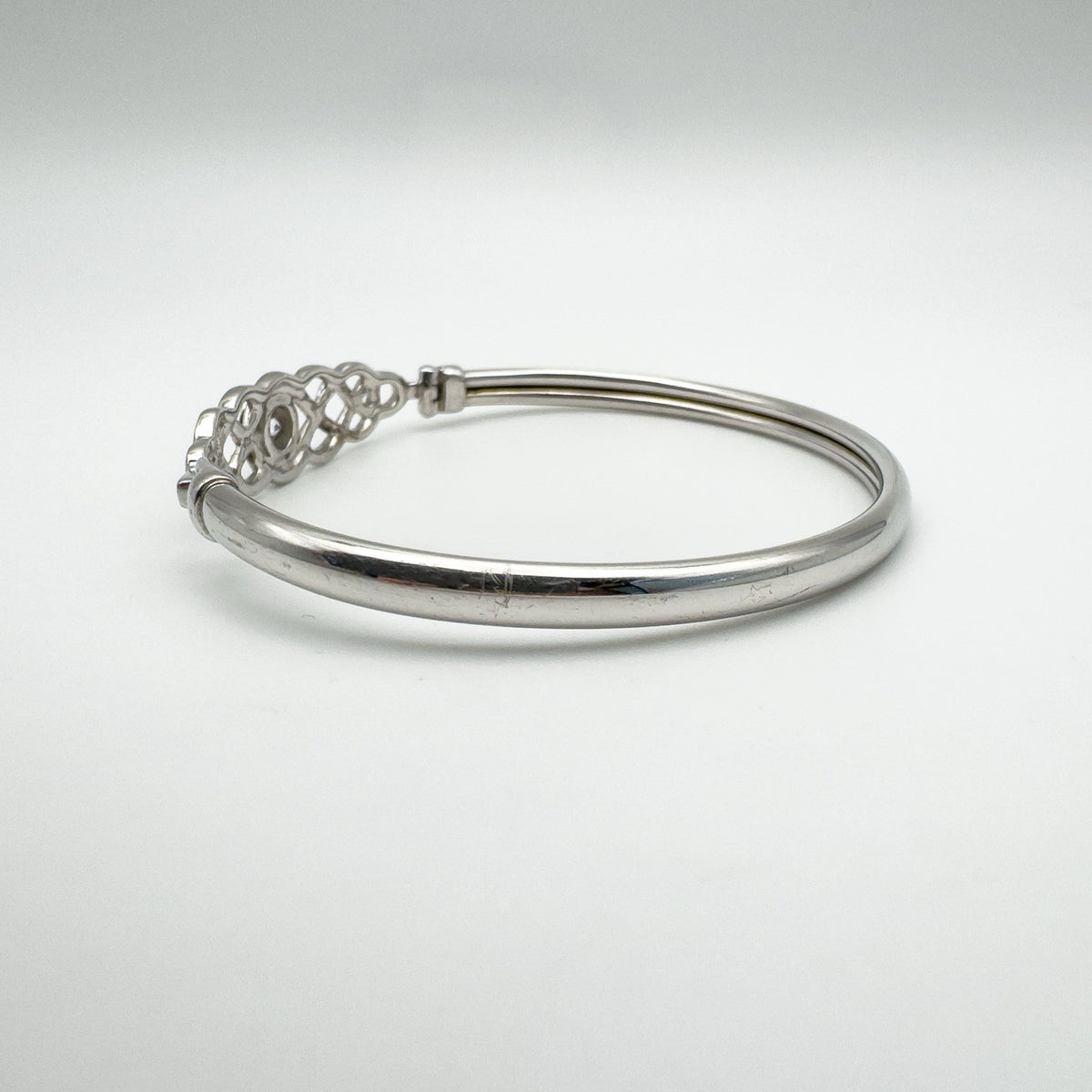 Right angle showing the bangle’s sleek form and hinge detail