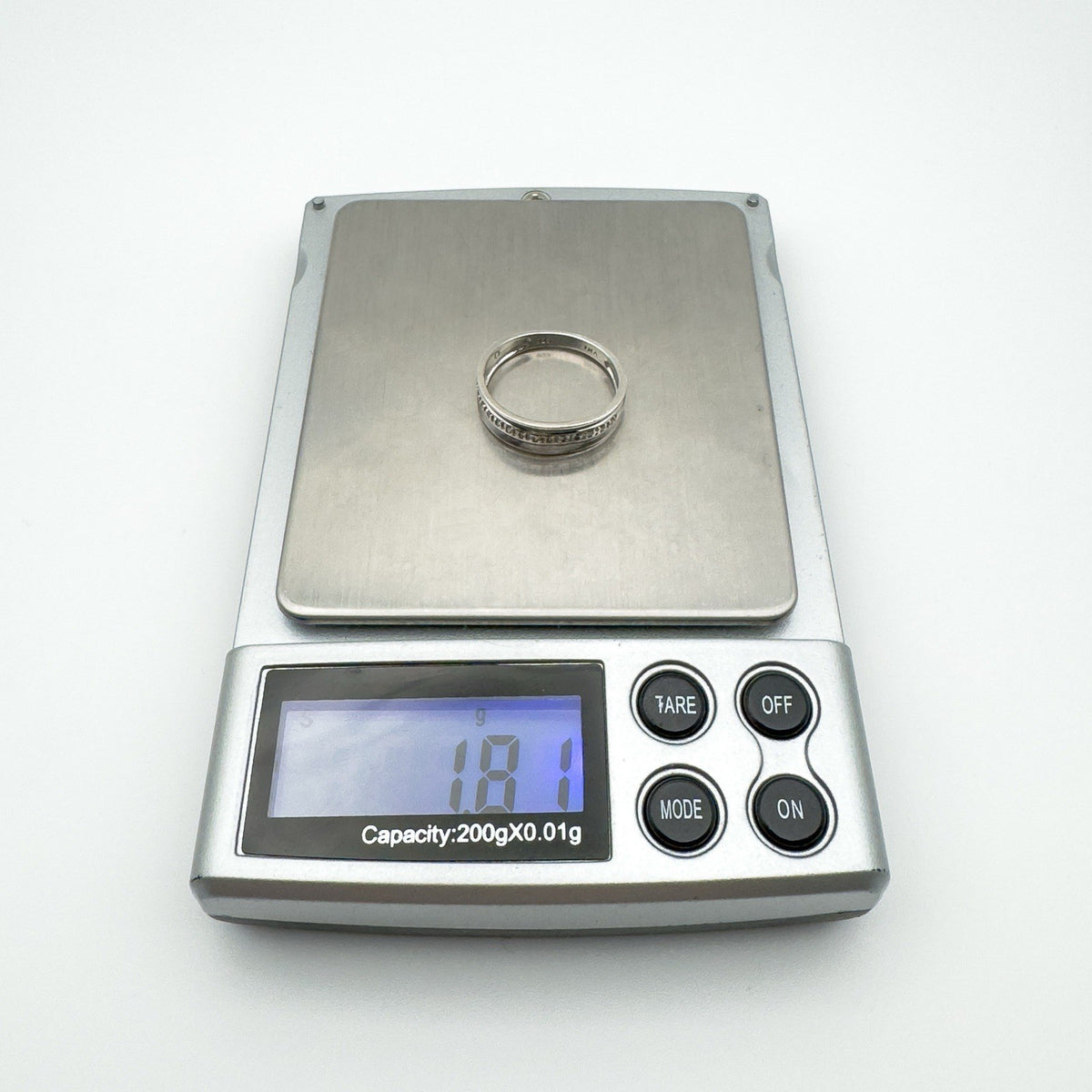 Sterling silver diamond ring displayed on digital scale reading 1.81g