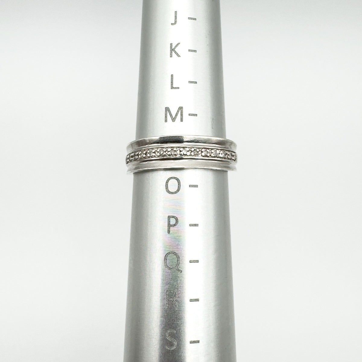 Diamond half hoop ring shown on ring mandrel measuring UK size N
