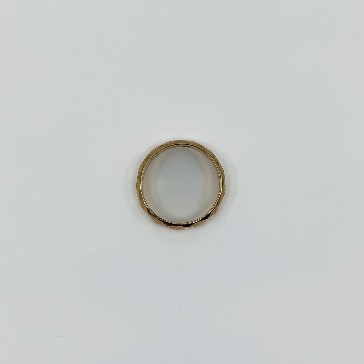 Top view of vintage 18ct rose gold faceted band ring showing the circular shape and polished finish.
