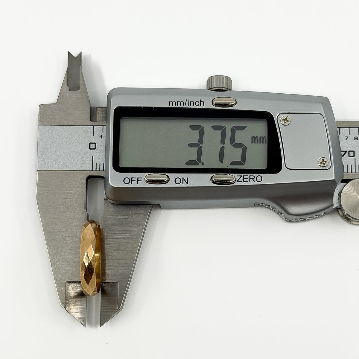Digital caliper measuring the vintage 18ct rose gold faceted band ring at approximately 3.75mm wide.