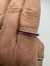 Ruby side of vintage white gold eternity ring shown worn on hand