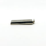 Low side view of the sterling silver ingot pendant with hallmark blocks along the front.