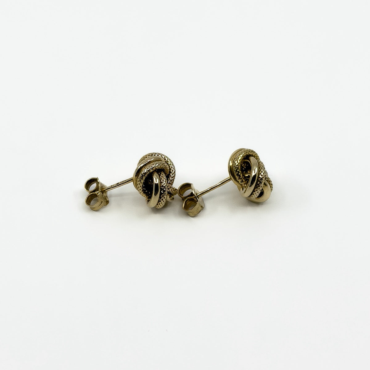 Side profile of vintage 9ct gold knot stud earrings in textured knot design