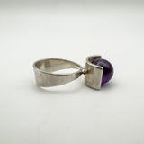 Side angle of silver modernist ring showing bold amethyst ball setting