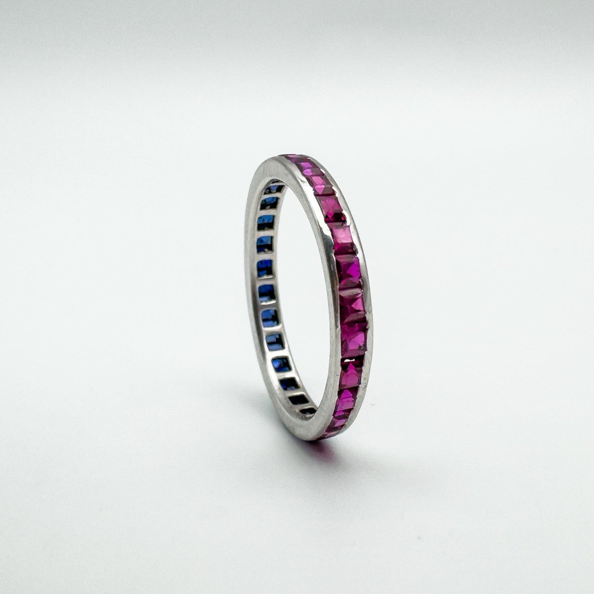Ruby side of vintage white gold full eternity ring with calibre cut stones
