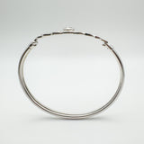 Side profile showing the depth of the CZ bezel setting above the knotwork