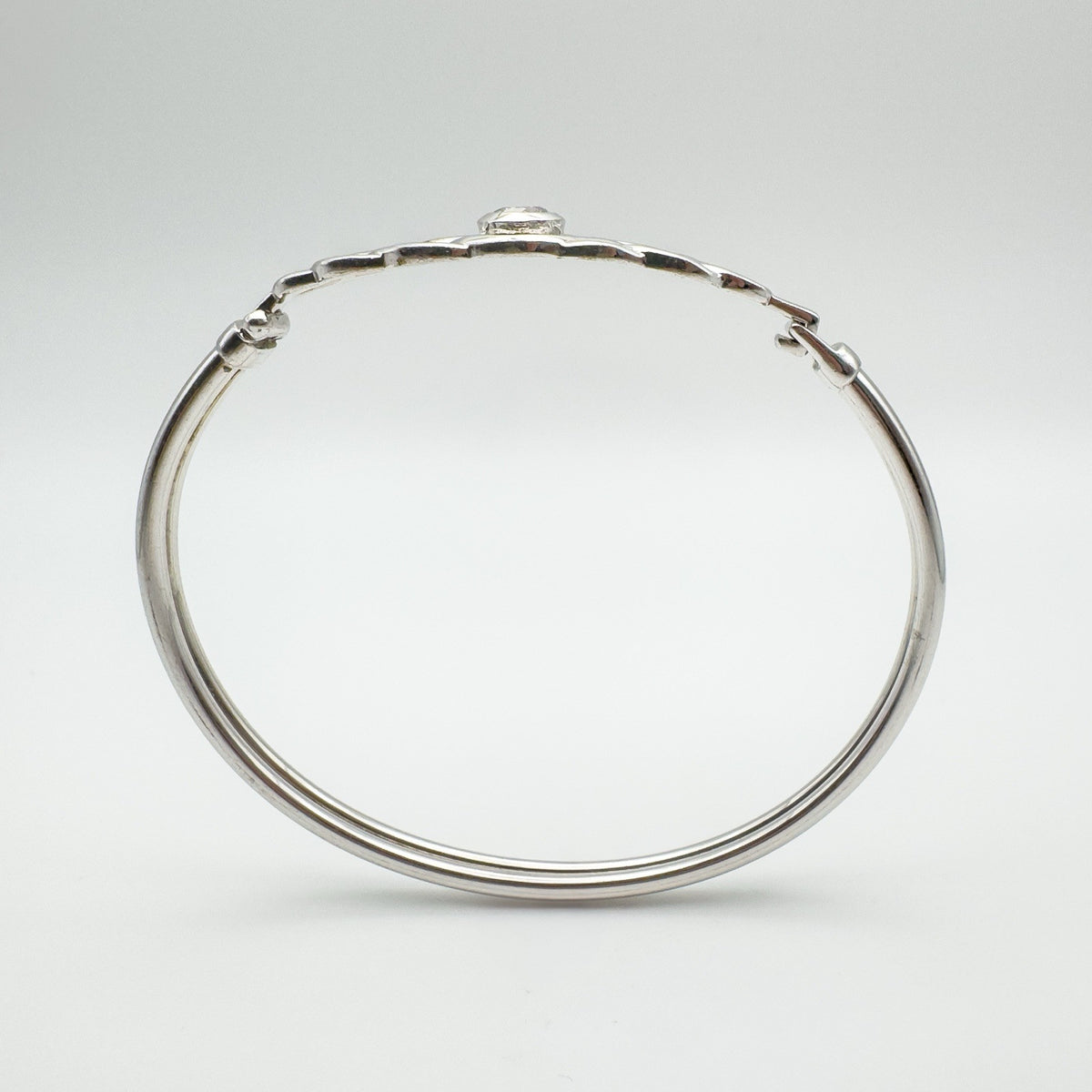 Side profile showing the depth of the CZ bezel setting above the knotwork