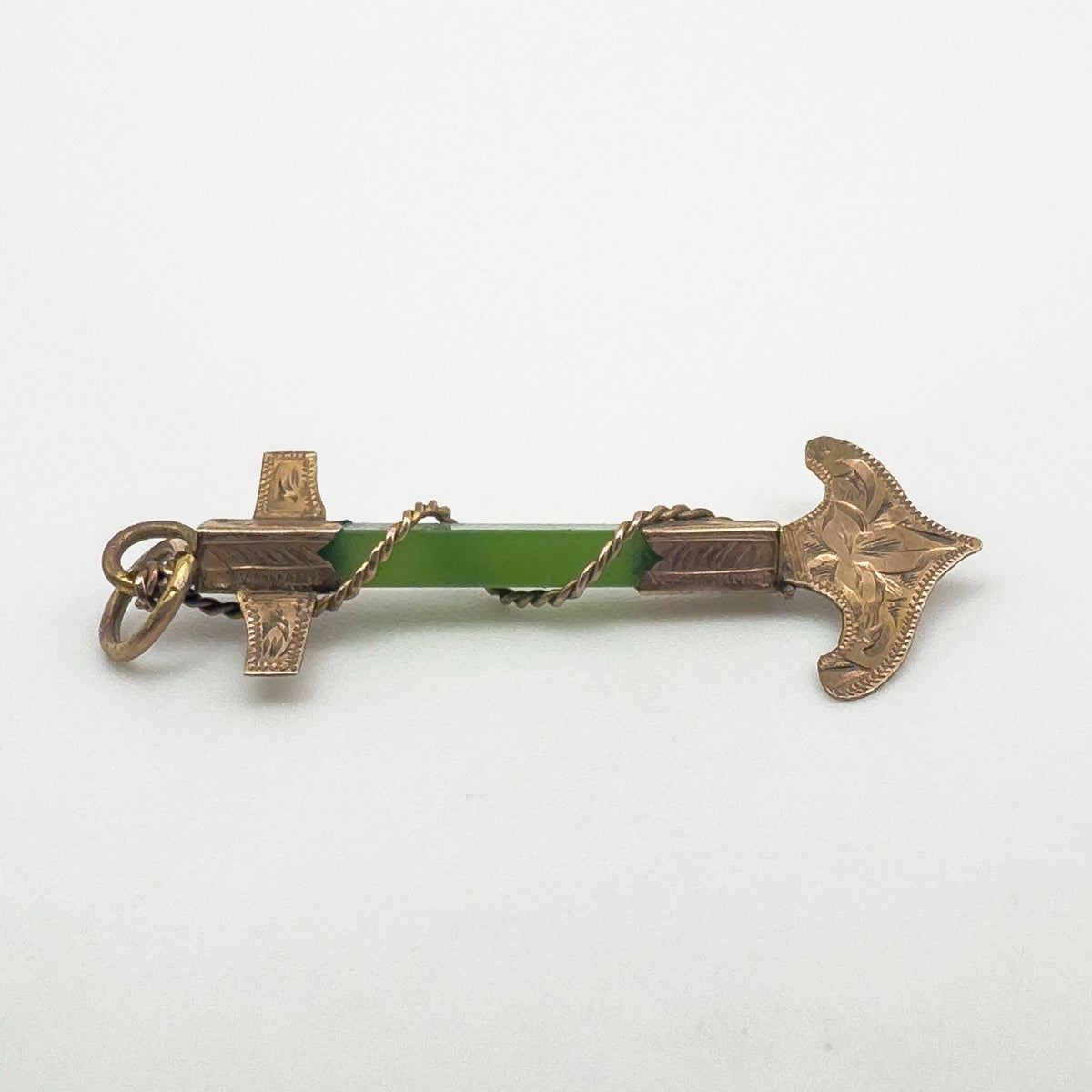 Side angle of antique rose gold anchor pendant with central green jade