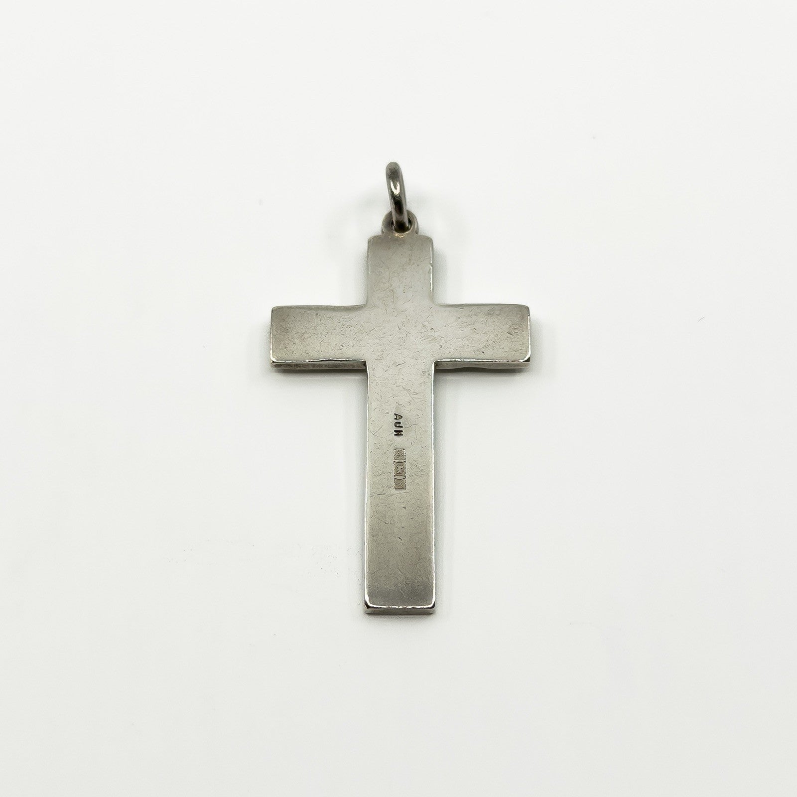 Reverse of the sterling silver cross pendant showing the maker and hallmark area.