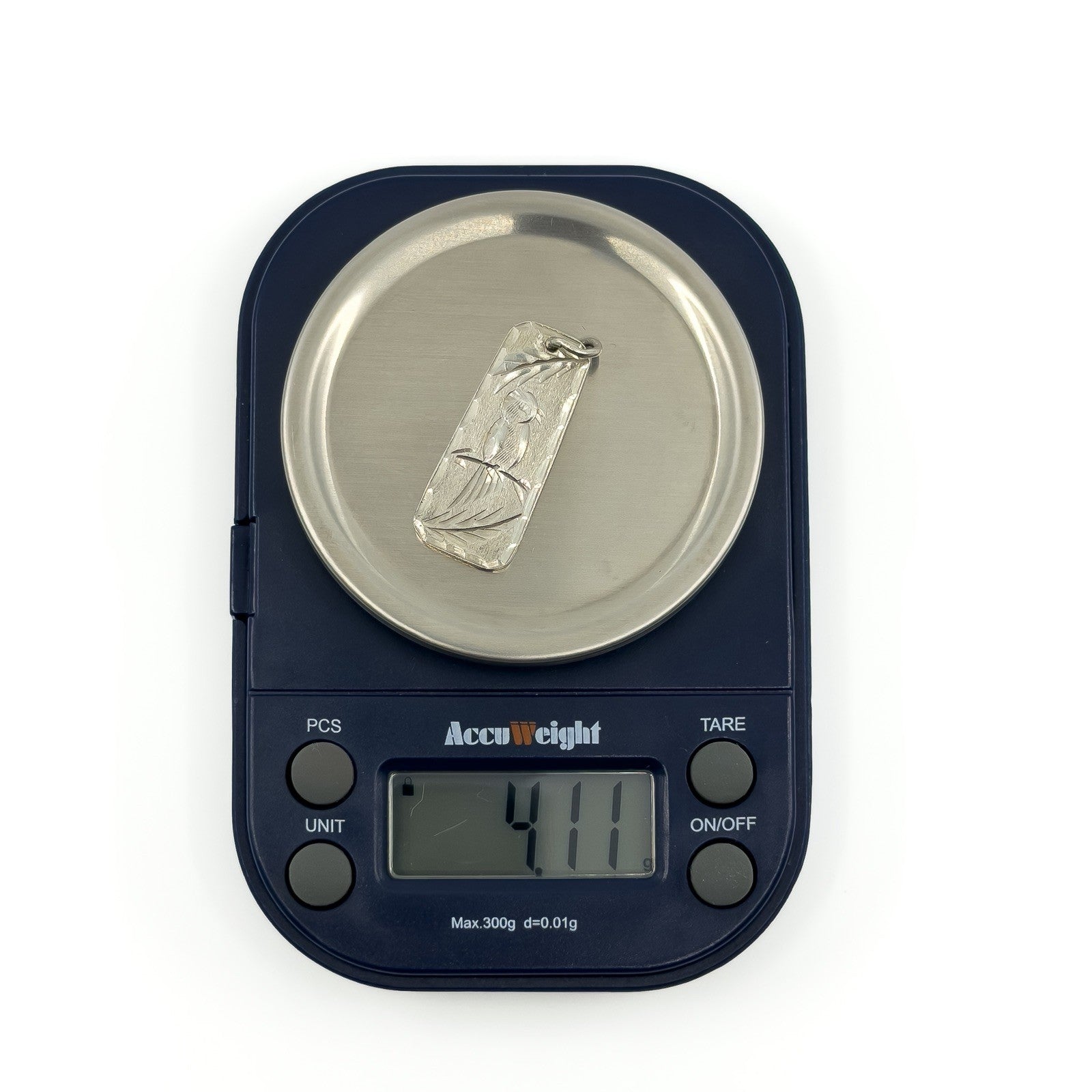 Vintage sterling silver ingot pendant shown on scales weighing approximately 4.1g.