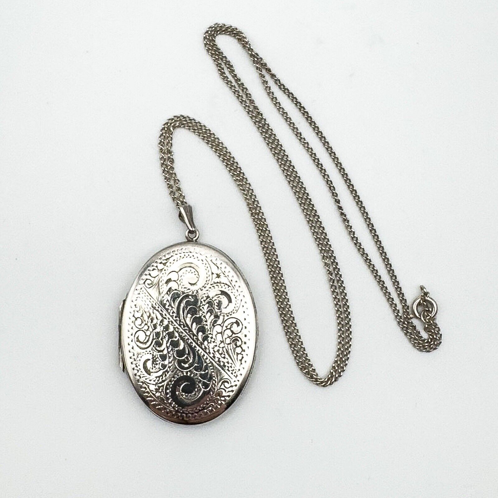 Full view of silver locket pendant with 24 inch curb chain and clasp