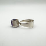 Side detail of vintage silver ring with amethyst, showing band and setting