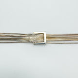 Close-up of square buckle on sterling silver snake chain bracelet
