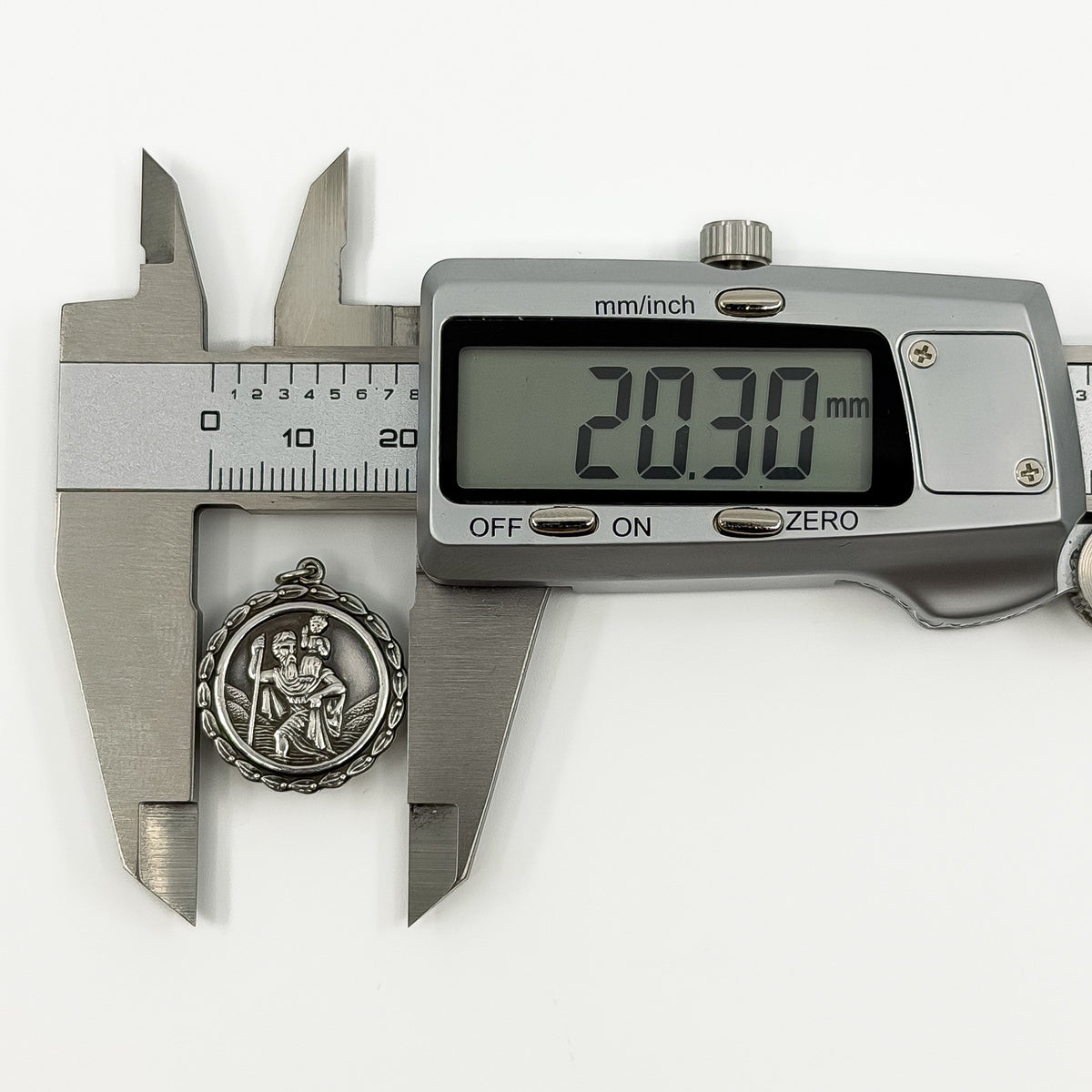 Digital caliper measuring the vintage sterling silver St Christopher pendant at approximately 20.30mm.