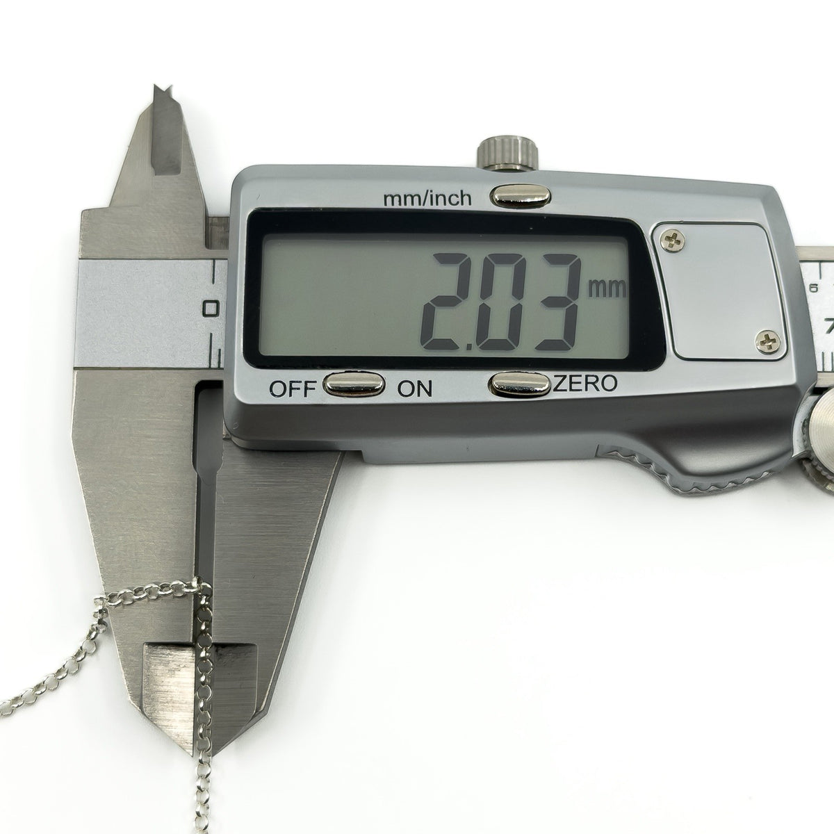 Close up of sterling silver chain links shown with caliper measurement of approximately 2mm