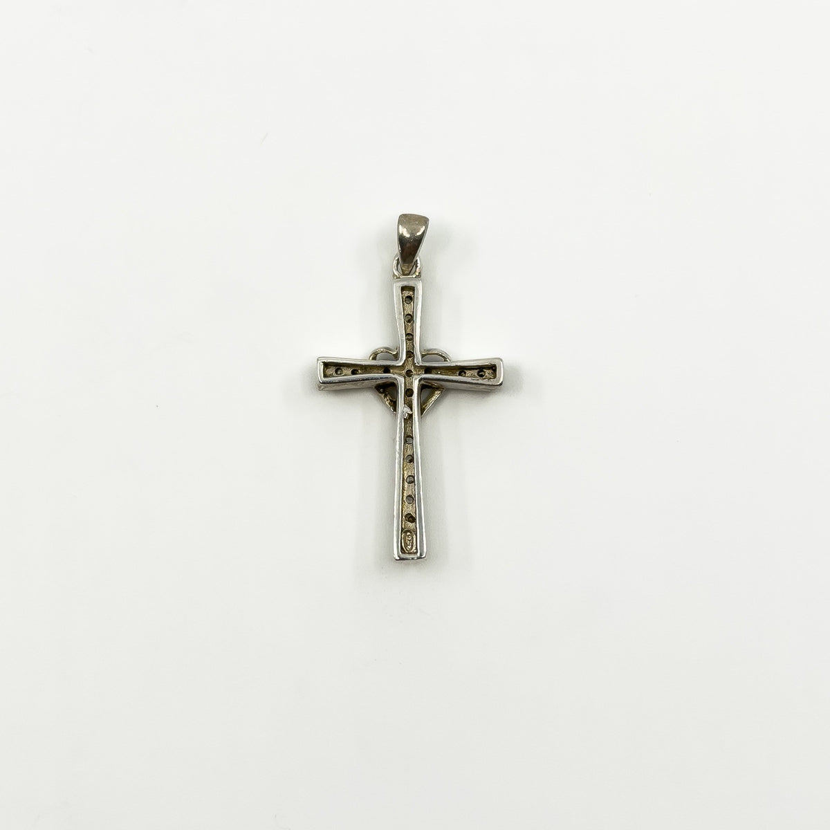 Reverse of sterling silver cross and heart pendant showing the back setting and 925 stamp
