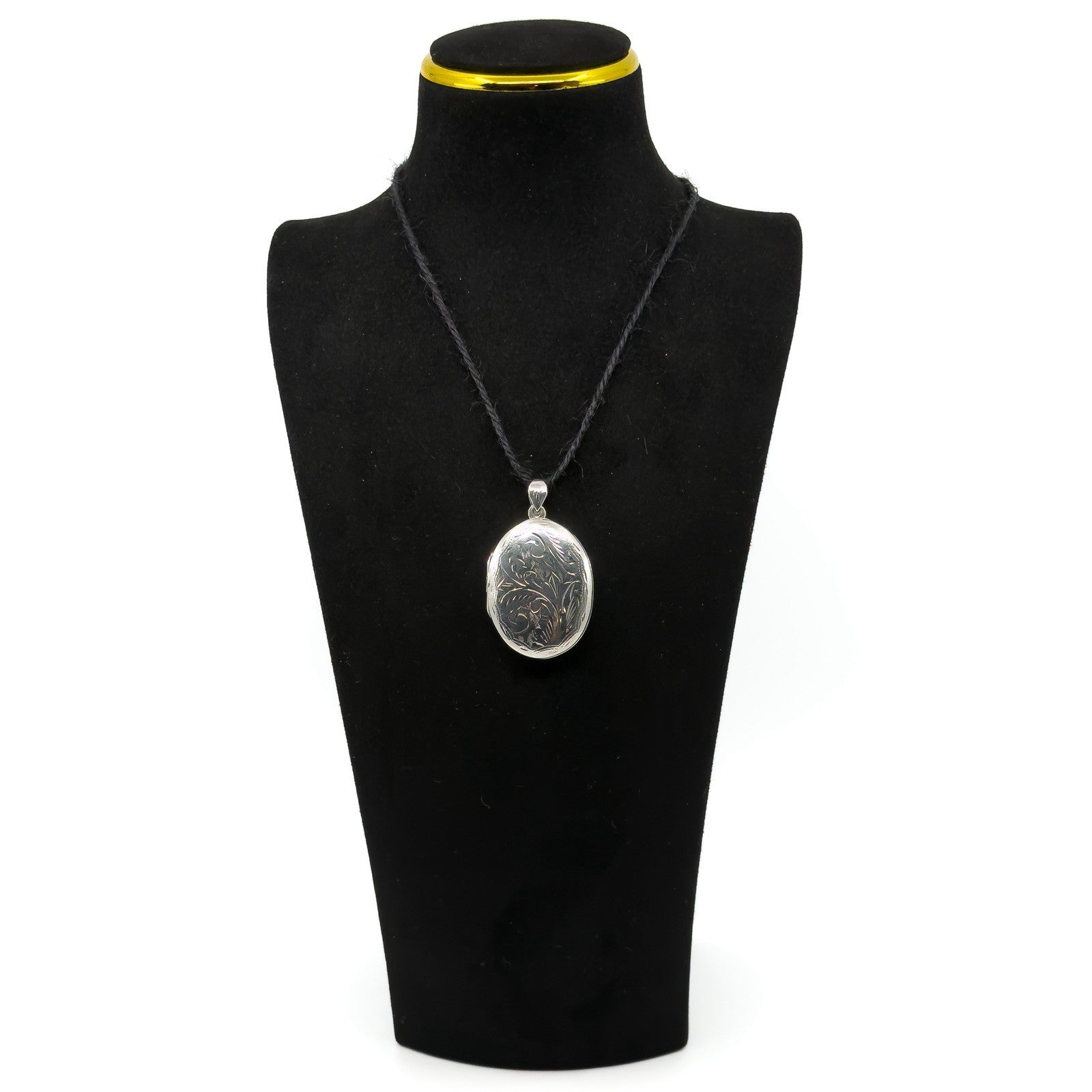 Sterling silver oval engraved photo locket shown on a black jewellery display bust