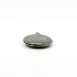 Side view of a vintage sterling silver oval photo locket showing engraved detail and rounded depth