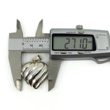 Digital calipers measuring the puffy heart sterling silver locket at approximately 27.1mm wide