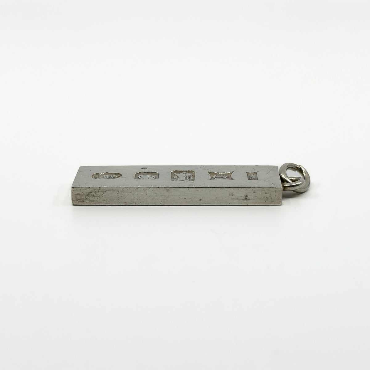 Side profile of vintage sterling silver rectangular ingot pendant showing chunky depth