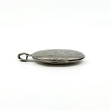 Side view of the sterling silver oval photo locket showing the hinge and engraved front