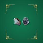 Preloved sterling silver oval lockets with engraved detail on green Art Deco background