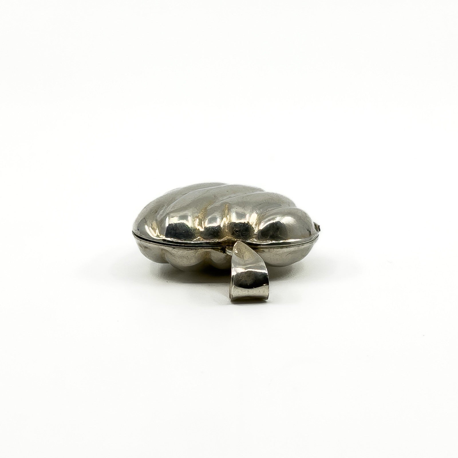 Low side view of the sterling silver puffy heart photo locket showing the rounded puffy shape.