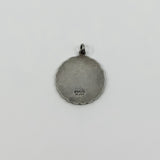 Back of vintage St Christopher pendant charm showing Sterling Silver stamp and scalloped edge.