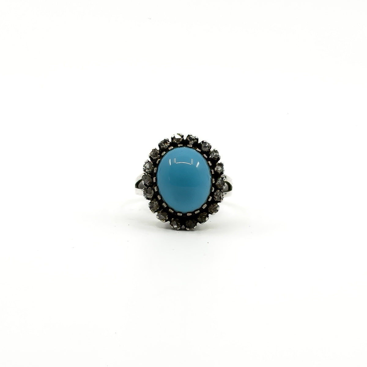 Sterling silver ring with oval turquoise and natural diamond halo setting