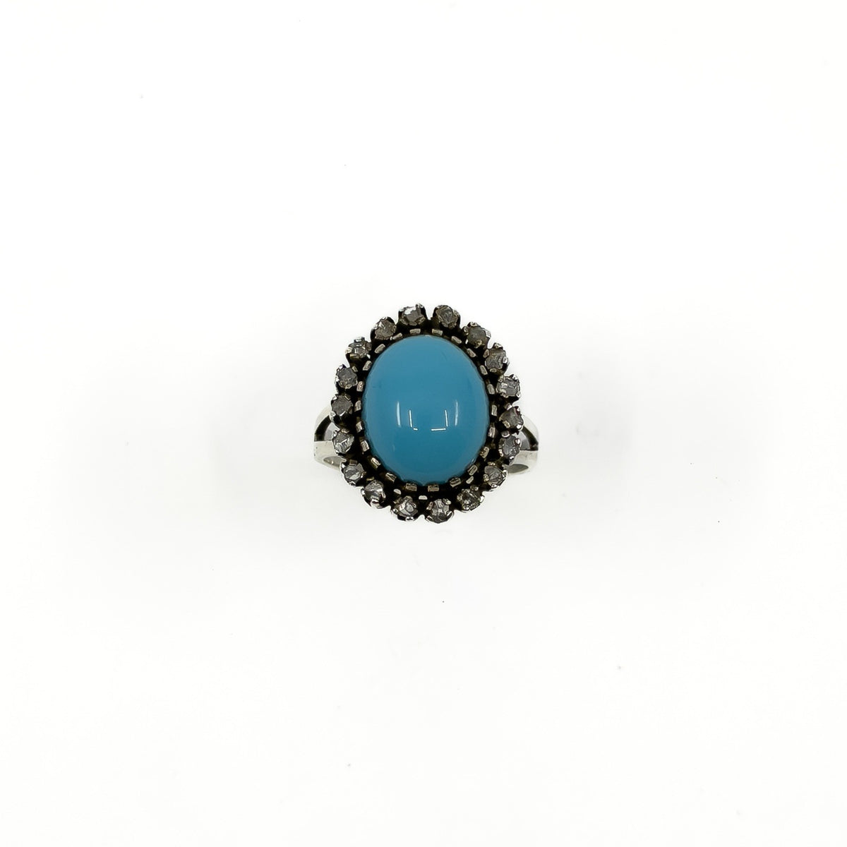 Front view of the turquoise cabochon and rough cut diamond halo ring